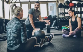 young women talking to a personal training coach