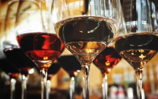 Glass of wine on a table, symbolizing the impact of alcohol on fitness goals