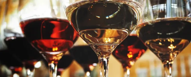 Glass of wine on a table, symbolizing the impact of alcohol on fitness goals