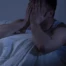 Man struggling to sleep due to stress and fatigue