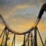 Silhouette of a rollercoaster at sunset symbolising emotional ups and downs in fitness journeys – blog by 5th Element Wellness Fitzroy