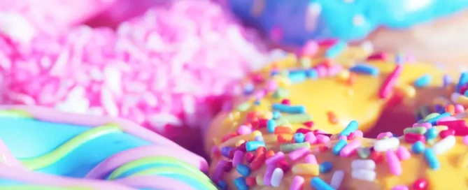 Colourful donuts with sprinkles, representing mindful indulgence and balanced eating without guilt