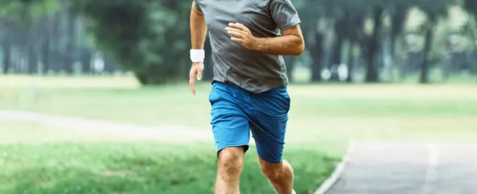 Middle-aged man running outdoors, representing sustainable fitness and recovery-focused training after 40