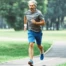Middle-aged man running outdoors, representing sustainable fitness and recovery-focused training after 40