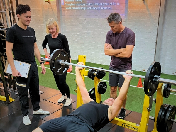 Over-40s personal training at 5th Element Wellness in Fitzroy North, with a coach supervising small-group strength training focused on control, technique, and longevity.