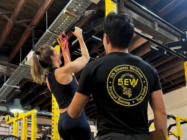 Personal training for adults over 40 at 5th Element Wellness in Fitzroy North, showing a coach observing controlled pull-ups to build strength, confidence, and long-term resilience.