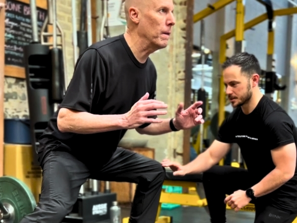 Personal training for beginners at 5th Element Wellness in Fitzroy North, showing a personal trainer coaching safe strength training for beginners during a guided movement assessment session.
