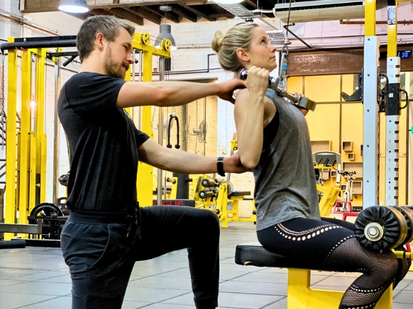 Personal trainer guiding a client through an exercise at 5th Element Wellness in Fitzroy North.