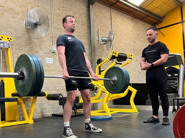 Personal training session at 5th Element Wellness in Fitzroy North with coach guiding a deadlift.