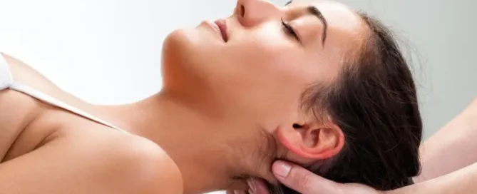 Osteopath performing neck treatment during a session featured in Fitzroy North local business spotlight by 5th Element Wellness