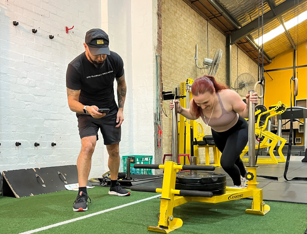 A coach guiding a 1:1 personal training session at 5EW Fitzroy North